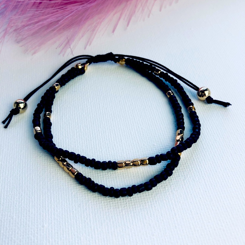 Sold.     Ankle bracelet with black beads and gold